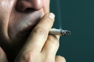Man Smoking Cigarette Unaware of Oral Health Problems Caused by Tobacco